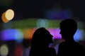 Silhouette of Couple Man and Woman kissing. couple in Love. lovers staying on urban, city town, yellow bokeh background. Romantic Royalty Free Stock Photo