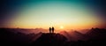 Silhouette Couple of man and woman reaching summit enjoying freedom and looking towards mountains sunset. Alps, Allgaeu Royalty Free Stock Photo