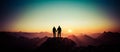 Silhouette Couple of man and woman reaching summit enjoying freedom and looking towards mountains sunset. Alps, Allgaeu Royalty Free Stock Photo