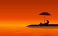 Silhouette couple man and woman sitting together on beach under sunset sky background Royalty Free Stock Photo