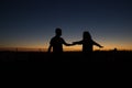 Silhouette couple playing scenario at sunset