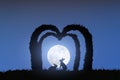 A silhouette of a pair of rabbits standing in a heart-shaped arch.