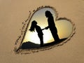 Silhouette couple in sand heart