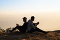 Couple sitting back to back using smart phones in natural Royalty Free Stock Photo