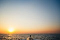 Silhouette of couple standing at the pier, watching the sunrise at the beach summer time Royalty Free Stock Photo