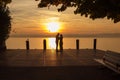 Silhouette of couple on sunset at Garda Lake, Italy.