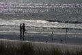 Silhouette of couple surfcasting 3