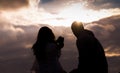 Silhouette of a couple taking a selfie in amazing summer sunset light