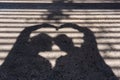 Silhouette of a couple with their heads and hands together forming a heart shape Royalty Free Stock Photo