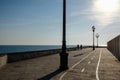 Silhouette of a couple walking along a seaside promenade at sunset Royalty Free Stock Photo