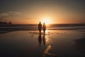 Silhouette of couple walking by the beach at sunset. Royalty Free Stock Photo