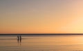 Silhouette Couple walking in the Ocean Sea at Sunset Royalty Free Stock Photo