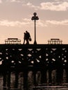 Silhouette of Couple Walking On Pier At Dusk Royalty Free Stock Photo