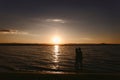 Silhouette couples in the sea at sunset Royalty Free Stock Photo