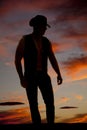 Silhouette cowboy arms down look to side