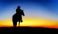 Cowboy On A Horse At Sunset. Silhouette