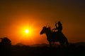 Silhouette Cowboy riding a horse