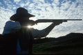 Silhouette of cowboy shooting rifle Royalty Free Stock Photo