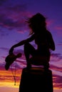 Silhouette cowgirl on barrel hold hat hair blow