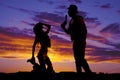 Silhouette cowgirl kneel on saddle look up at cowboy