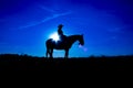 Silhouette cowgirl on horse at sunrise in blue 2