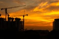 Silhouette of crane and building construction site at sunset Royalty Free Stock Photo