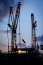 Silhouette crane at construction site