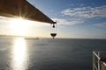 Silhouette of crane of the merchant cargo container vessel. Royalty Free Stock Photo