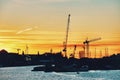 silhouette cranes at harbor against sky during sunset Royalty Free Stock Photo