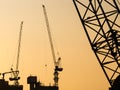 Silhouette Cranes working on Building Construction site sunset sky Royalty Free Stock Photo