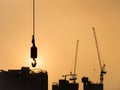 Silhouette Cranes working on Building Construction site sunset sky Royalty Free Stock Photo