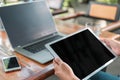 Silhouette of cropped shot of a young man working from home using smart phone and notebook computer, woman`s hands using smart Royalty Free Stock Photo