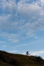 Silhouette of a cross country cyclist going downhill Royalty Free Stock Photo