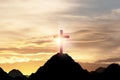 Silhouette Cross or Crucifixion of Jesus Christian on top of mountain with sunlight and clouds sky. Christianity religion concept Royalty Free Stock Photo