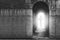 Silhouette of the cross at the end of tunnel with ray of sunlight behind Royalty Free Stock Photo