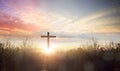 worship concept, Silhouette cross Jesus Christ on grass autumn sunrise background Royalty Free Stock Photo