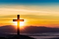 Silhouette of cross on mountain sunset background