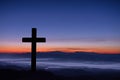 Silhouette of cross on mountain sunrise. Royalty Free Stock Photo