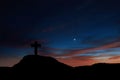 Silhouette of a cross on the mountain at sunrise Royalty Free Stock Photo