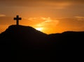 Silhouette of a cross on the mountain at sunrise Royalty Free Stock Photo