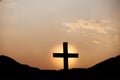 Silhouette of cross on mountain at sunset. concept of religion Royalty Free Stock Photo