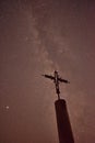 Silhouette of cross at night with beautiful milky way background