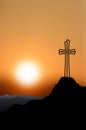 Silhouette of a cross on top of a mountain Royalty Free Stock Photo