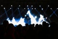 Silhouette of crowd in a concert. Spotlights on the stage Royalty Free Stock Photo