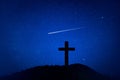 Silhouette of crucifix cross on mountain at night time with star and space background. Royalty Free Stock Photo