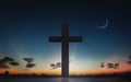 Silhouette of crucifix cross at sunset time and night sky with moon background Royalty Free Stock Photo