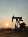 Silhouette of a crude oil drilling well