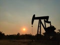 Silhouette of a crude oil drilling well
