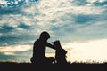 Silhouette cute boy and dog playing at sky sunset Royalty Free Stock Photo