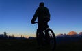 Silhouette of a cyclist against the backdrop of a stunning outback sunset Royalty Free Stock Photo